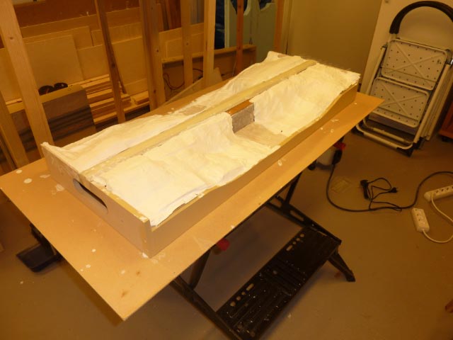 Ett lapptäcke av gipsindränkta pappershandukar och därpå ett lager Sculptamold.